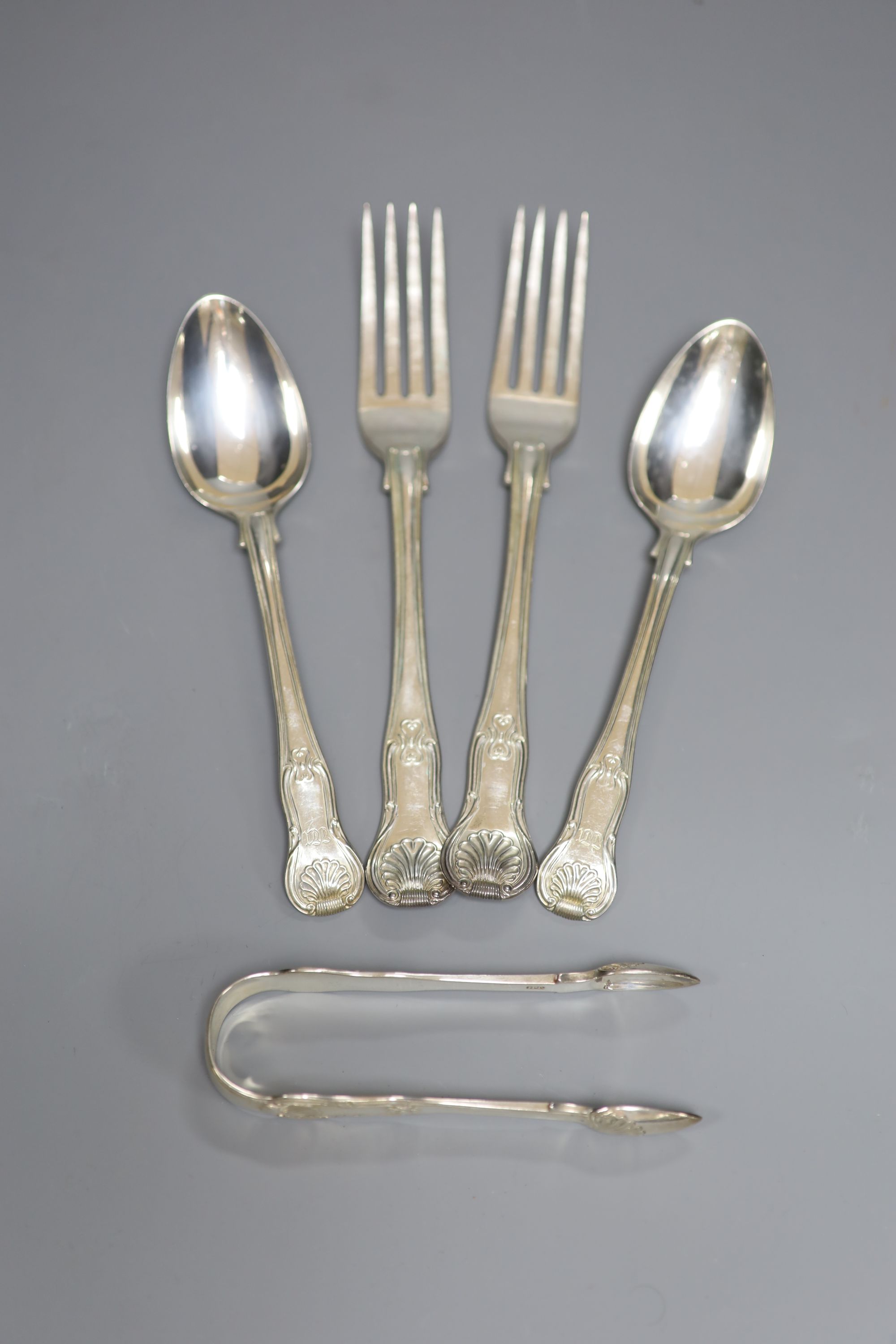 A pair of George IV silver hourglass pattern table forks and pair of dessert spoons and a pair of sugar tongs, 12.7oz